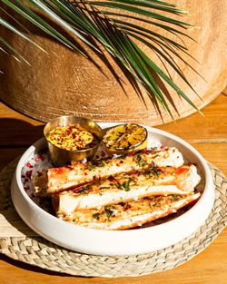 Grilled crab legs served with charred lemon and spicy dipping sauce at Casa Madera West Hollywood.